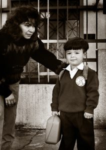 Madre despidiendo a su hijo para el Colegio