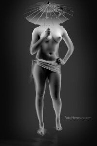 Chica desnuda con sombrilla